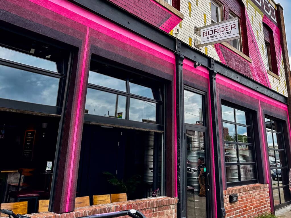 local border brewing facade is pink with roll up windows