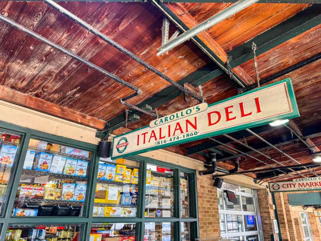 carollos italian deli sign in kansas city at historic city market with wooden ceilings