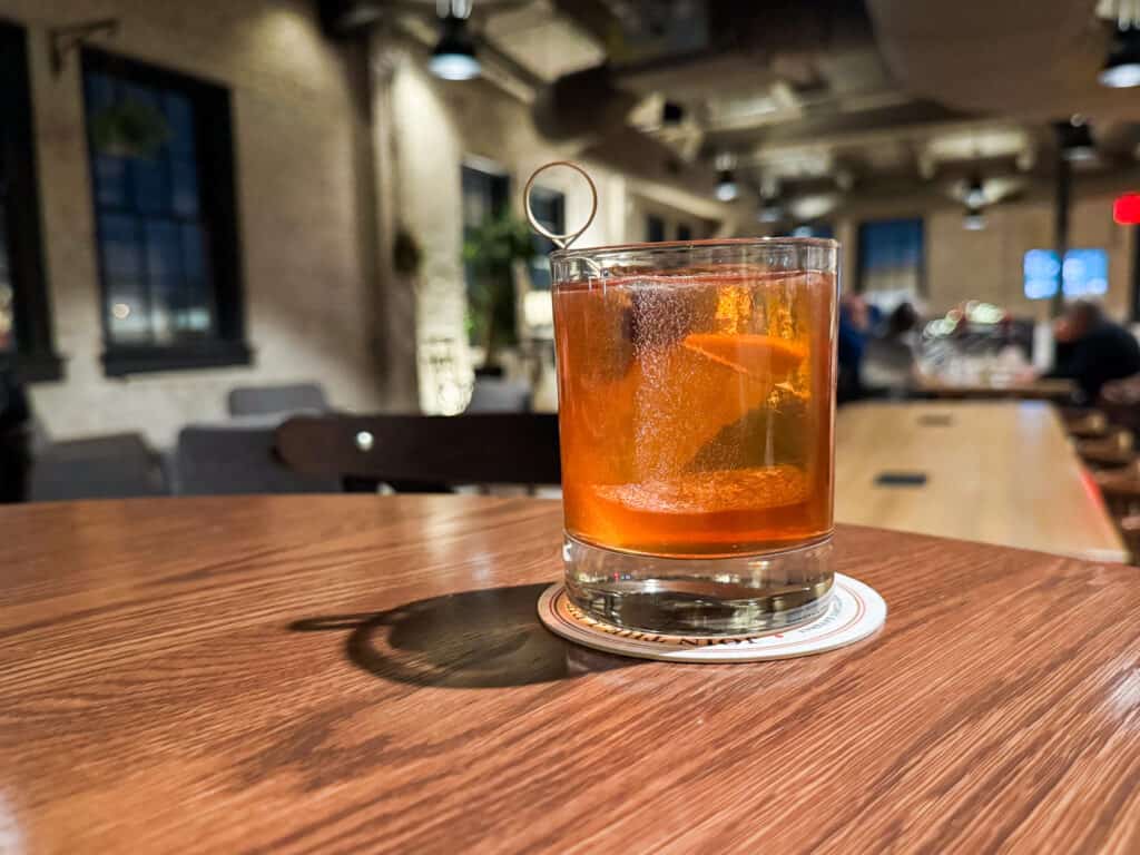 old fashioned on a wooden table at rieger distillery