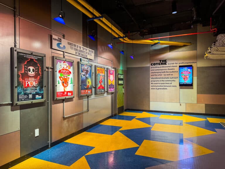 entryway to the coterie theatre with show posters on a wall