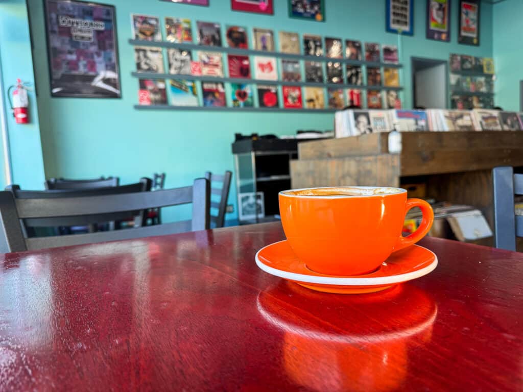 orange coffee cup at a table in a record store in kansas city